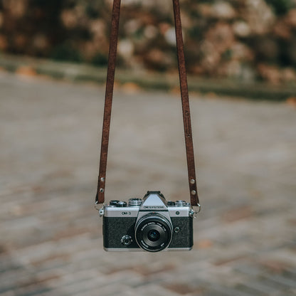 Showing the new OM SYSTEM OM-3 camera with brown leather strap made by Arch Appearance