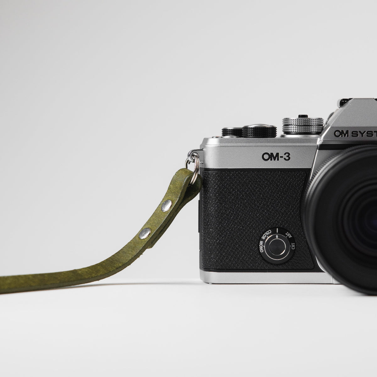 OM SYSTEM OM-3 camera with green Arch Appearance camera strap