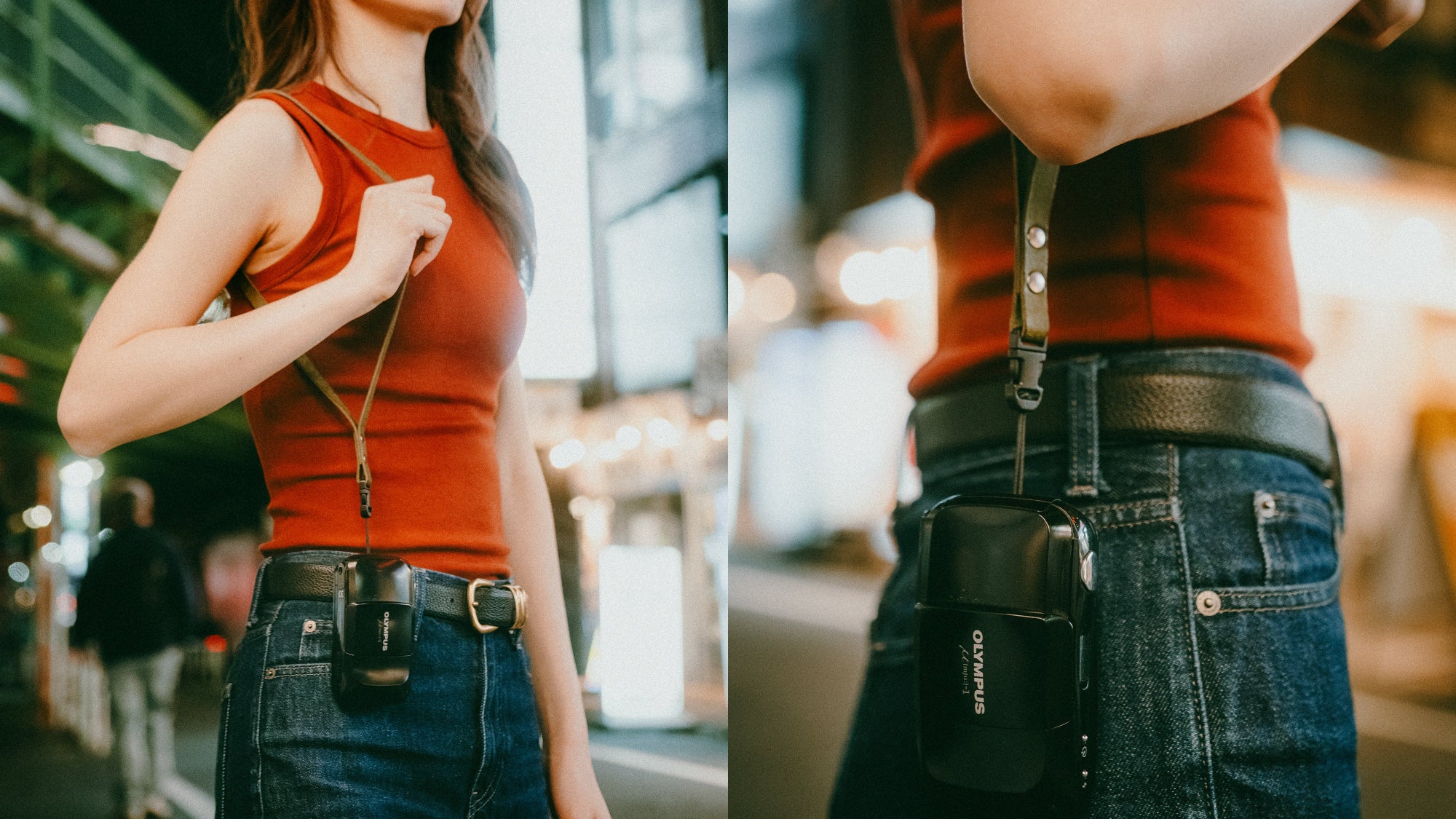 Person hanging her leather camera strap with an old Olympys film camera in an urban setting.