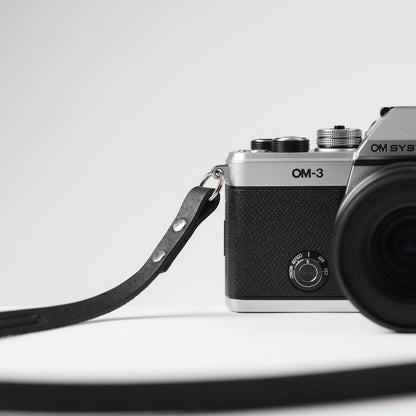 The new OM SYSTEM OM-3 camera with Arch Appearance black leather camera strap