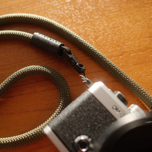 om system om-3 camera connected to a quick release rope camera strap
